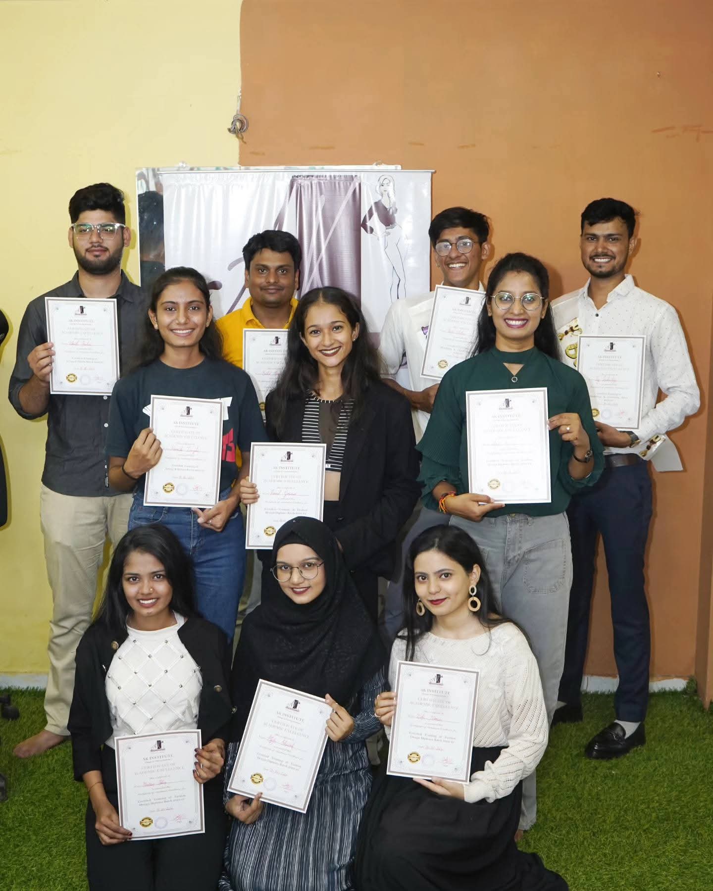Fashion design diploma batch with their certificates of academic excellence