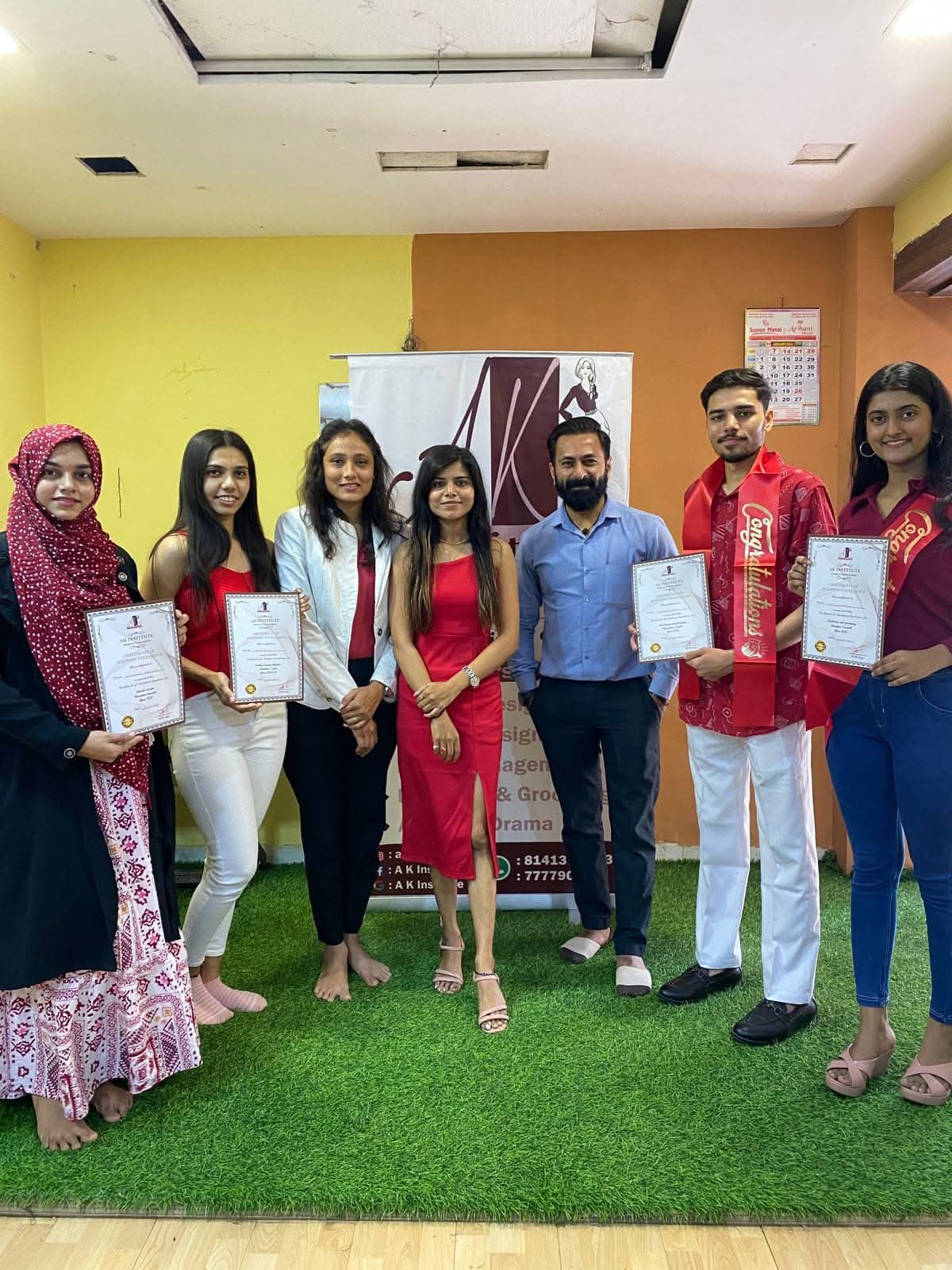 AK Institute students with their certificates of academic excellence