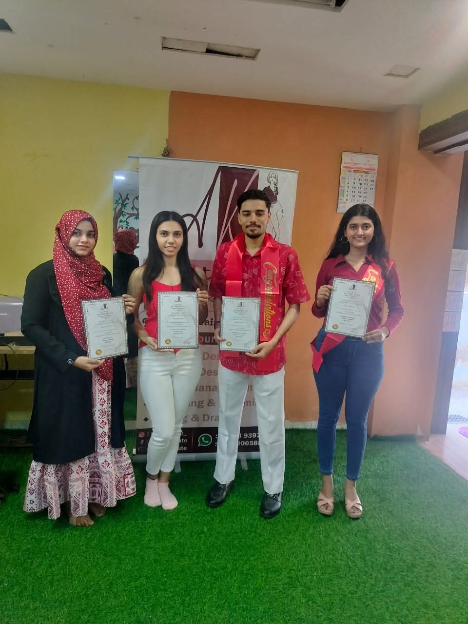 Students holding AK Institute course completion certificates